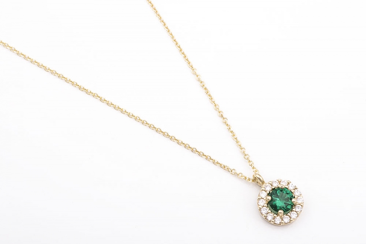 K9 gold round rosette necklace with a green stone.