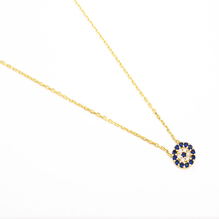 K14 gold necklace with a round evil eye adorned with blue stones.