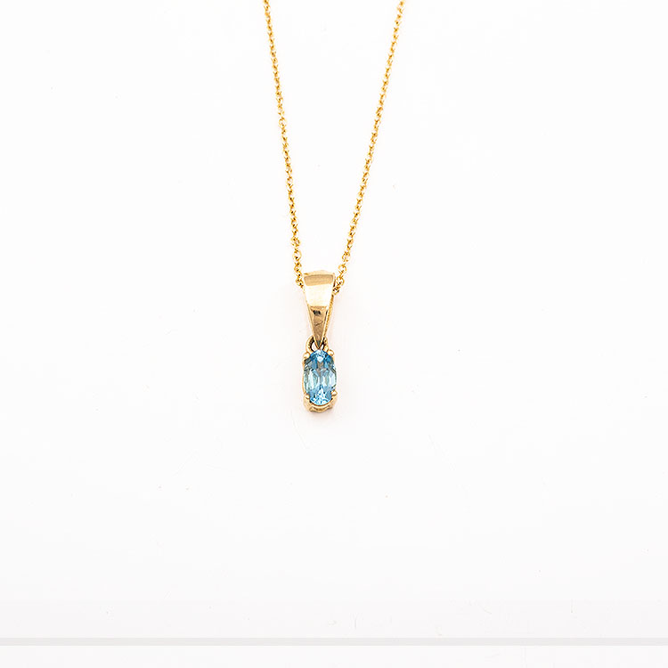 K14 gold necklace with an oval light blue stone.