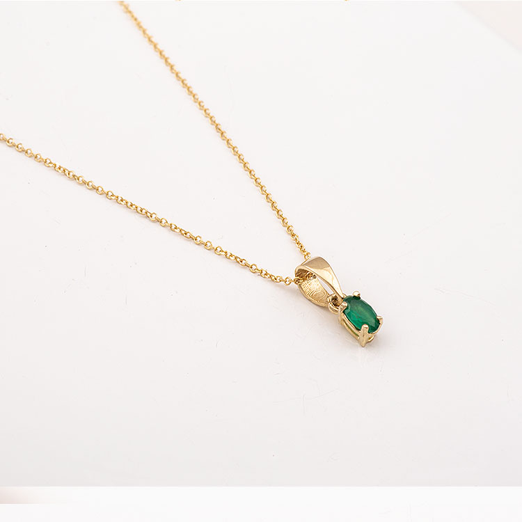 K14 gold necklace with an oval green stone.