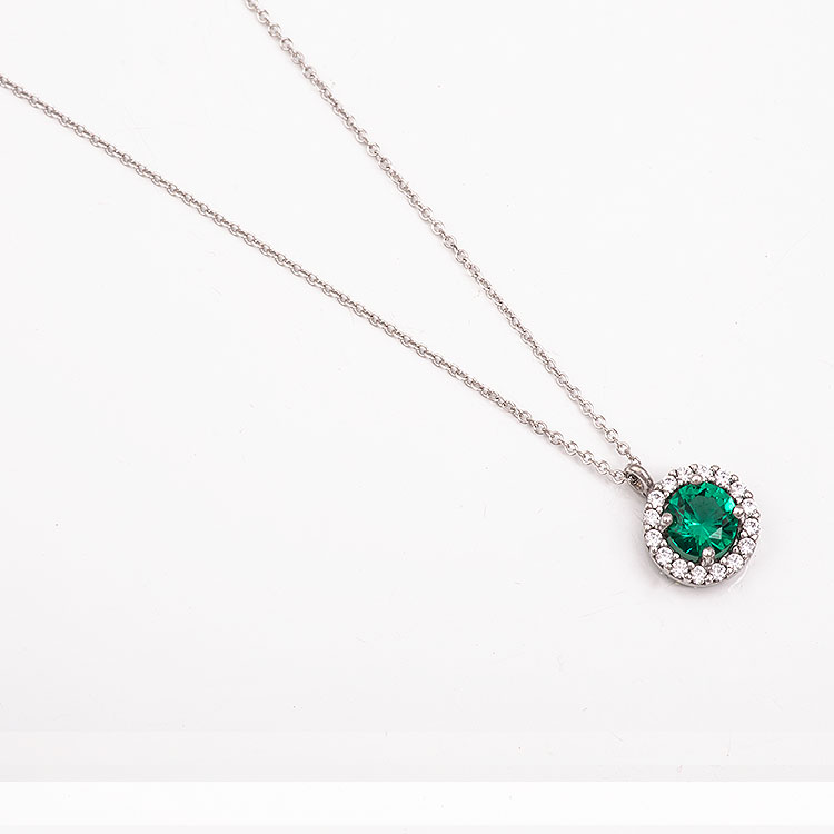 K9 white gold round rosette necklace with a green stone.