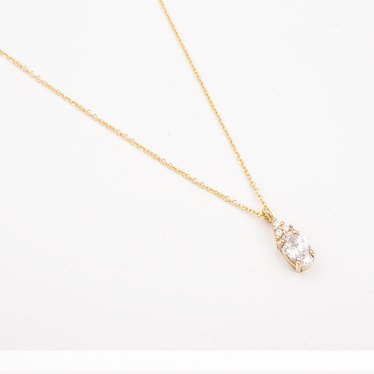 K9 gold necklace with an oval white stone.