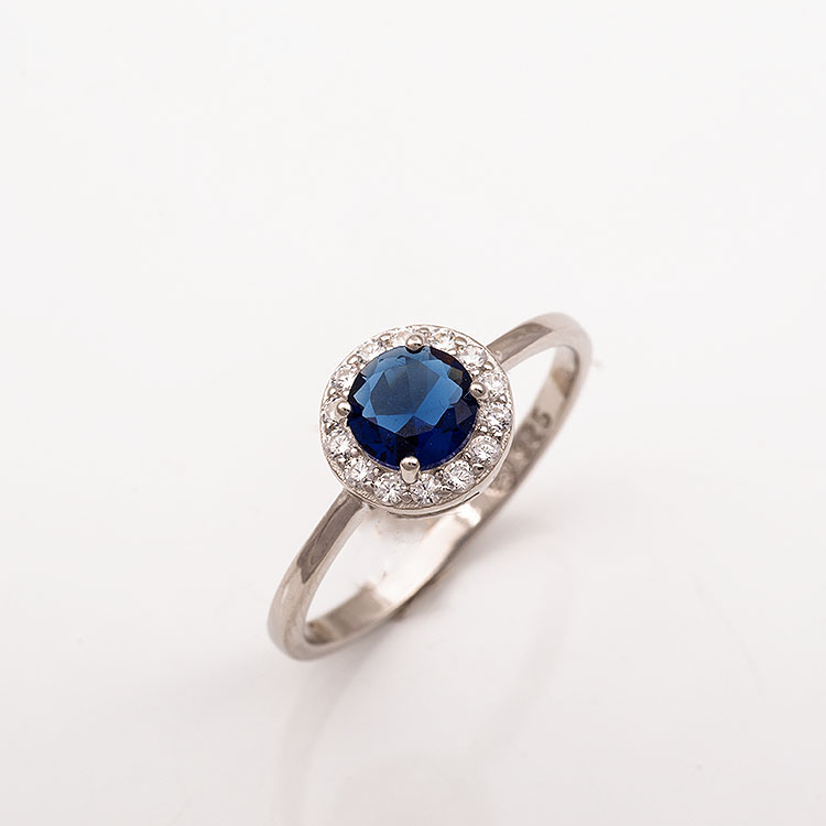 Ασημένιο δαχτυλίδι στρογγυλή ροζέτα με μπλε πέτρα.