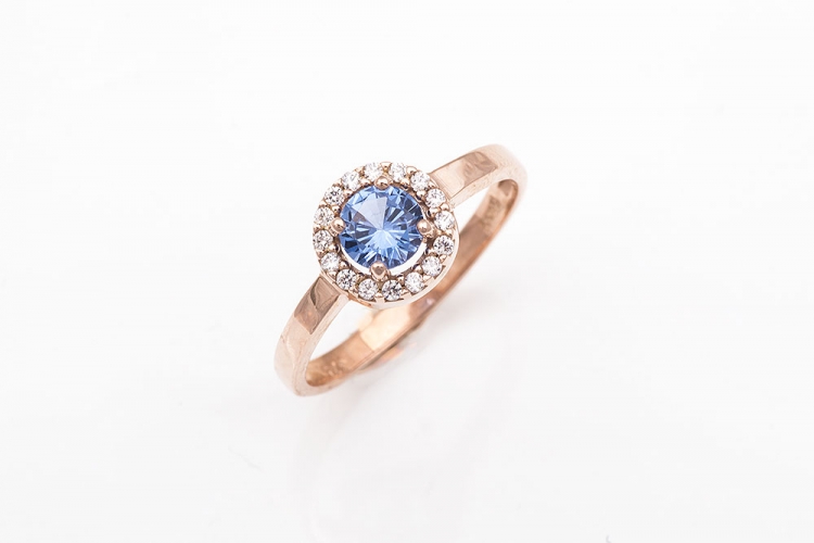 Δαχτυλίδι σε ροζ χρυσό Κ9 ροζέτα με γαλάζια πέτρα.